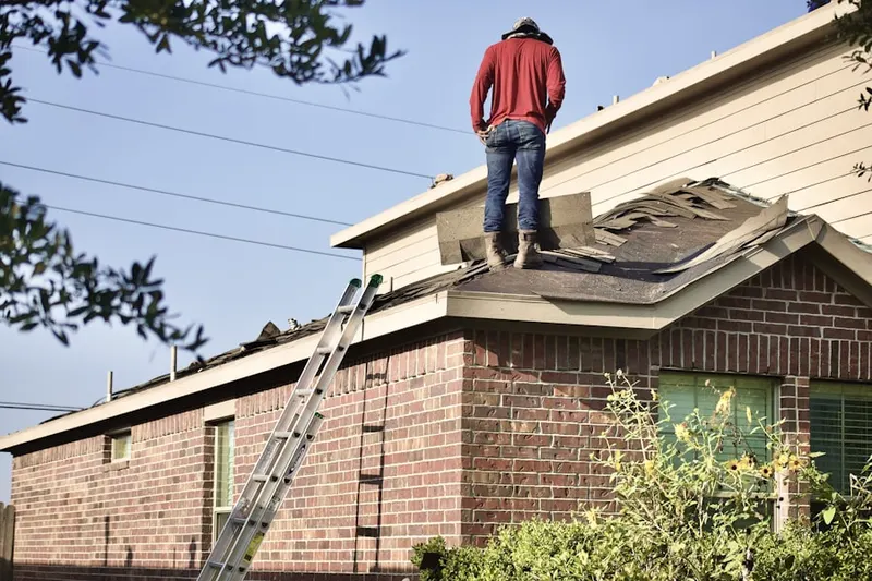 Professional roofer working on a residential roof in Downtown Rialto